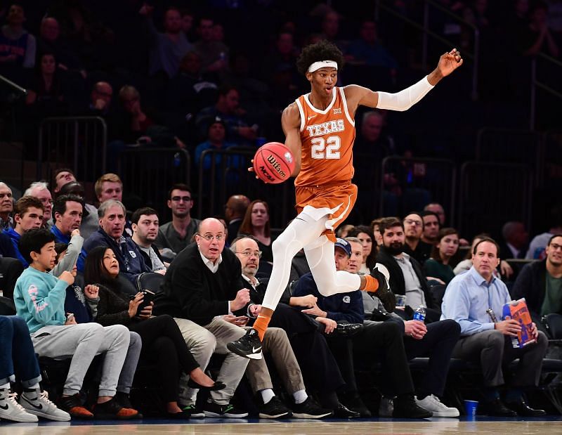 Kai Jones #22 of the Texas Longhorns jumps to save the ball from going out of bounds