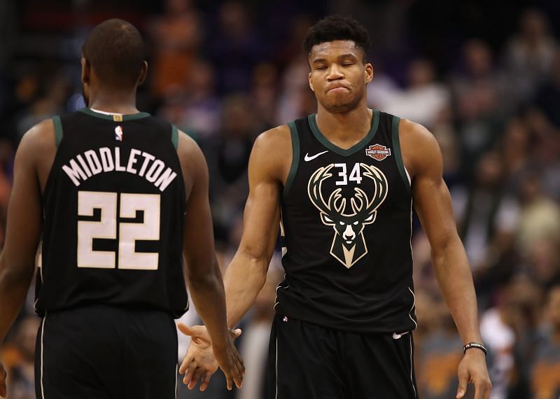 Giannis Antetokounmpo of the Milwaukee Bucks high fives Khris Middleton as he fouls out of the NBA game against the Phoenix Suns at Talking Stick Resort Arena