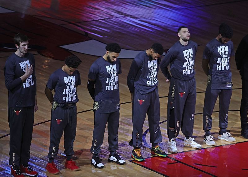 Members of the Chicago Bulls wearing shirts honoring Martin Luther King Jr. day stand during the National Anthem before a game against the Houston Rockets.