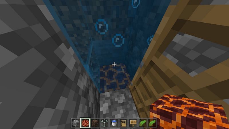 Replace the block below your kelp with soul sand to create upward bubbles and a magma block to create downward bubbles