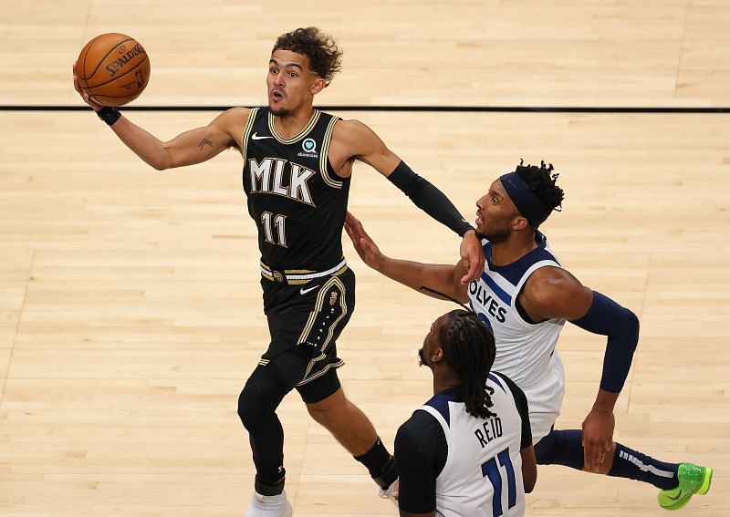 Trae Young #11 of the Atlanta Hawks looks to pass as he drives against Josh Okogie #20 and Naz Reid #11 of the Minnesota Timberwolves during the first half at State Farm Arena on January 18, 2021 (Photo by Kevin C. Cox/Getty Images)