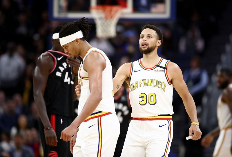 Stephen Curry talks to Damion Lee of the Golden State Warriors in a game against the Toronto Raptors.