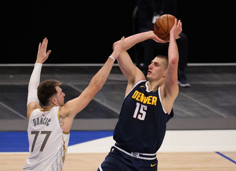 Nikola Jokic #15 of the Denver Nuggets takes a shot against Luka Doncic #77 of the Dallas Mavericks.