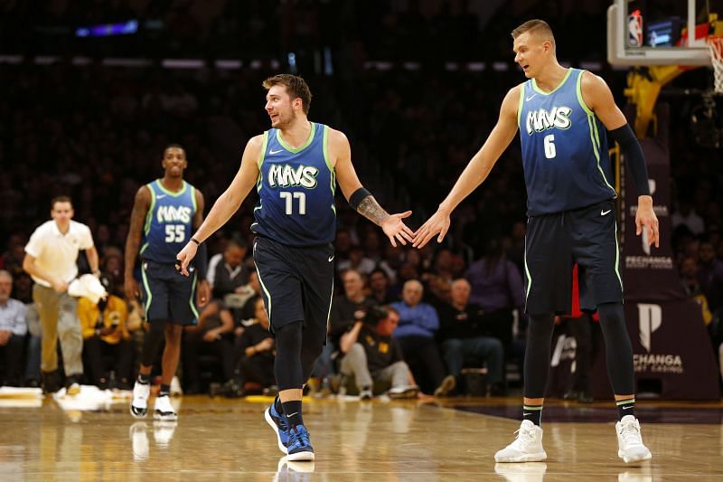 Luka Doncic and Kristaps Porzingis high-fives during the game against the LA Lakers.&nbsp;