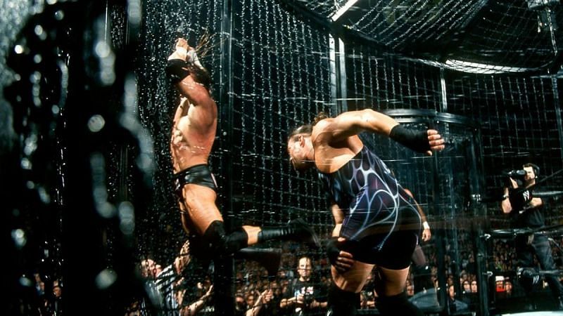RVD tossig Triple H into the chamber wall during the Elimination Chamber match