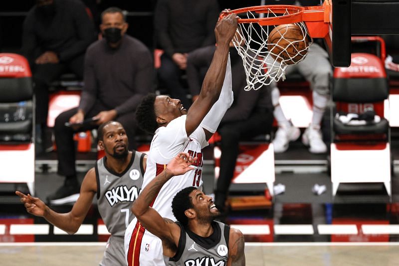 Bam Adebayo of the Miami Heat dunks as Kevin Durant and Kyrie Irving of the Brooklyn Nets defend during the first half at Barclays Center