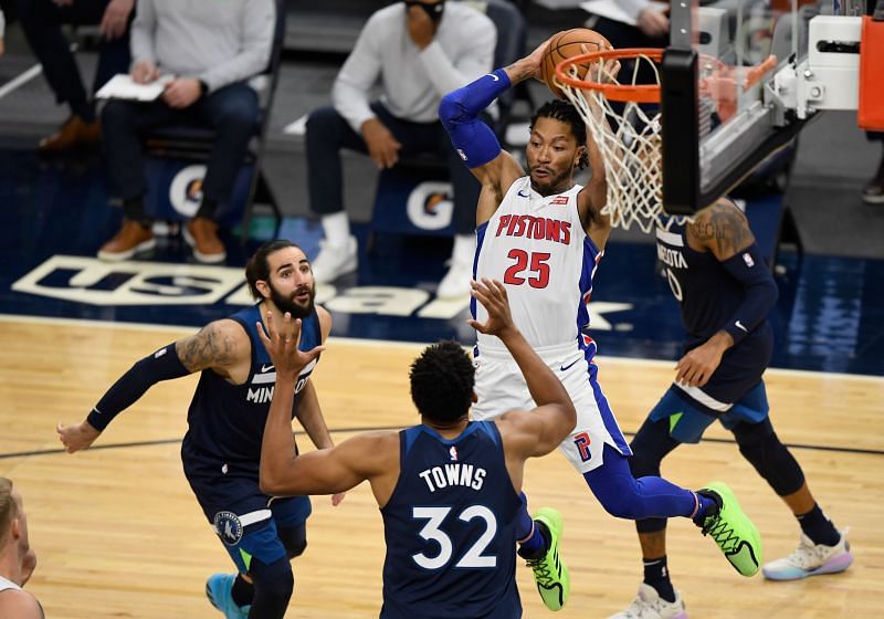 Derrick Rose #25 of the Detroit Pistons passes the ball against Ricky Rubio #9 and Karl-Anthony Towns #32 of the Minnesota Timberwolves during the fourth quarter of the season-opening game.