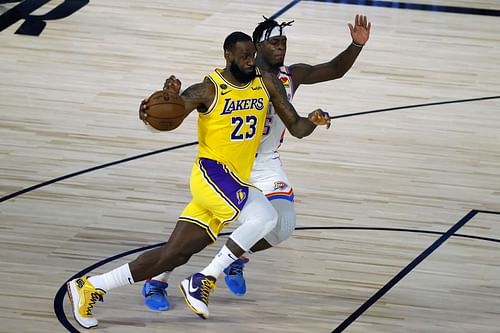 LeBron James of the LA Lakers battles OKC Thunder's Luguentz Dort