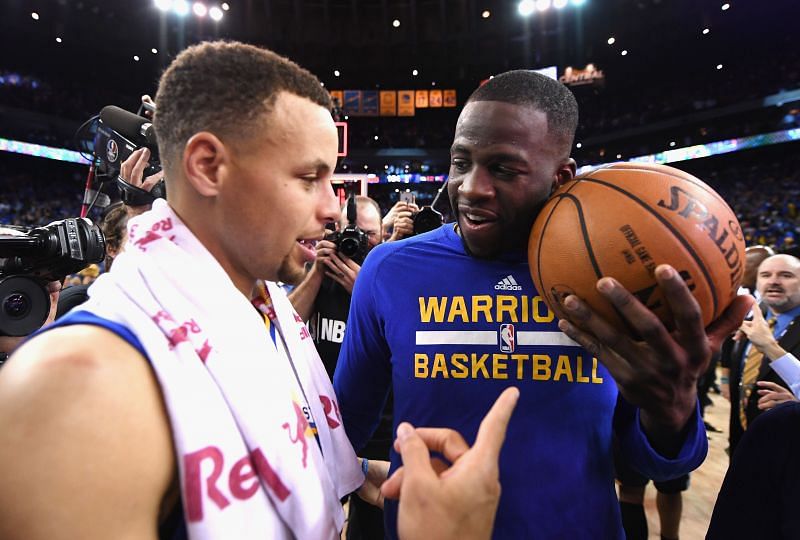 Stephen Curry #30 of the Golden State Warriors (L) and Draymond Green #23 celebrate their historic 2015-16 regular season.