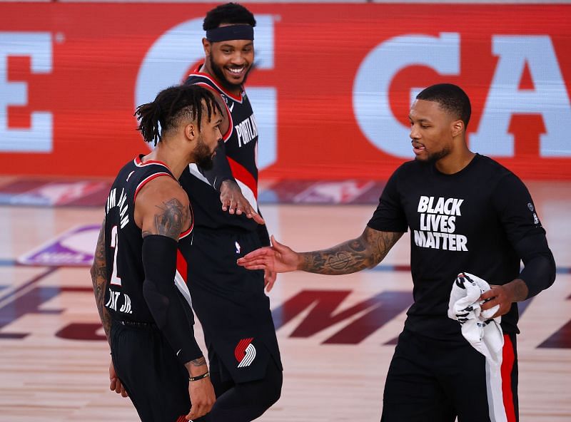 Gary Trent Jr. of the Portland Trail Blazers celebrates a three against the Denver Nuggets with teammates Damian Lillard and Carmelo Anthony of the Portland Trail Blazers