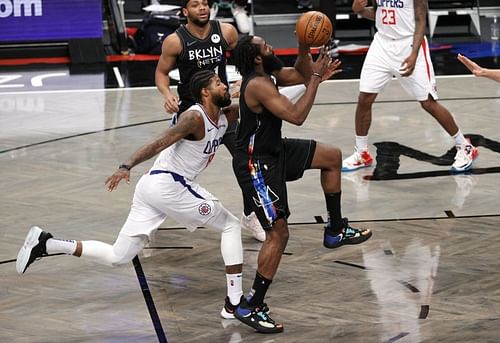 James Harden #13 of the Brooklyn Nets shoots as Paul George #13 of the LA Clippers defends