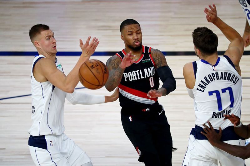 Damian Lillard of the Portland Trail Blazers against Kristaps Porzingis and Luka Doncic of the Mavericks