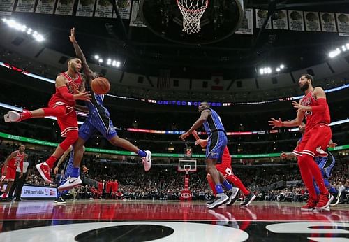 the Chicago Bulls pass while under pressure against the Orlando Magic