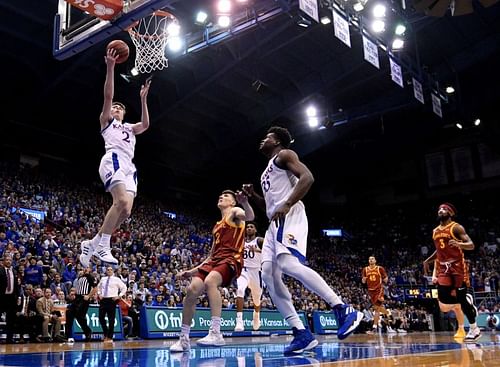 Christian Braun #2 of the Kansas Jayhawks lay the ball up against Caleb Grill #2 of the Iowa State Cyclones