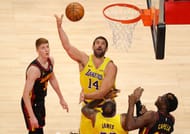 Marc Gasol #14 of the LA Lakers attacks the basket against Kevin Huerter #3 and Clint Capela #15 of the Atlanta Hawks