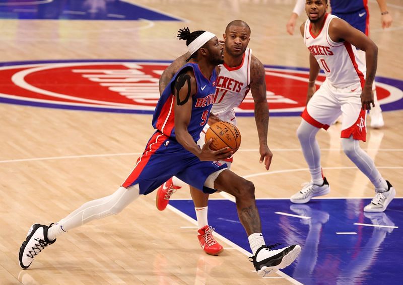 Jerami Grant of the Detroit Pistons drives to the basket past P.J. Tucker of the Houston Rockets
