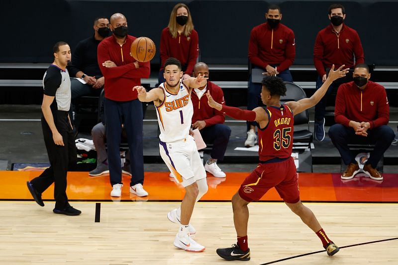 Cleveland Cavaliers&#039; Isaac Okoro guards Devin Booker of the Phoenix Suns
