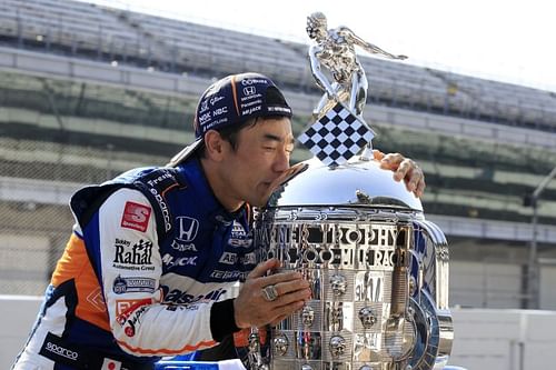 Takuma Sato kisses the Borg-Warner Trophy after winning the Indianapolis 500 for the second time. (Photo by Andy Lyons/Getty Images)