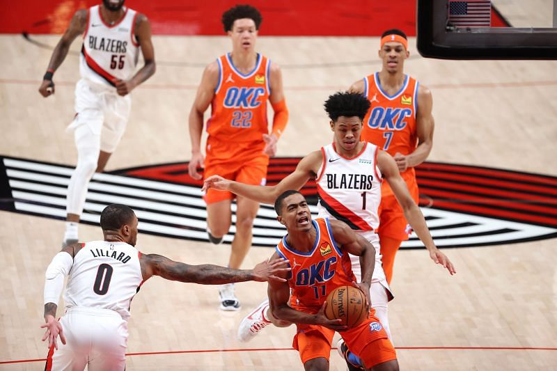 Theo Maledon #11 of the Oklahoma City Thunder works to the basket against Damian Lillard #0 of the Portland Trail Blazers in the first quarter at Moda Center on January 25, 2021, in Portland, Oregon. (Photo by Abbie Parr/Getty Images)