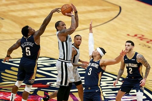 DeMar DeRozan (#10) of the San Antonio Spurs is blocked by Eric Bledsoe (#5) of the New Orleans Pelicans.