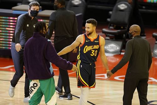 Stephen Curry of the Golden State Warriors greets D'Angelo Russell of the Minnesota Timberwolves 