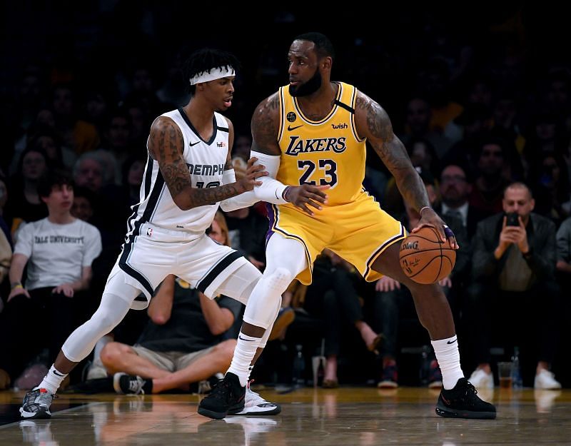 LeBron James #23 of the Los Angeles Lakers posts up Ja Morant #12 of the Memphis Grizzlies