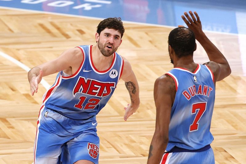 Joe Harris (#12( reacts with Kevin Durant (#7) of the Brooklyn Nets