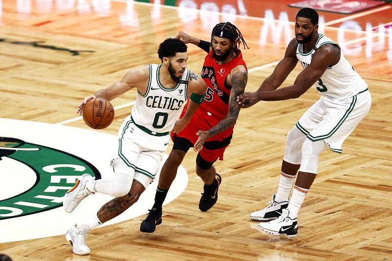 Jayson Tatum #0 of the Boston Celtics dribbles down court past DeAndre&#039; Bembry #95 of the Toronto Raptors 