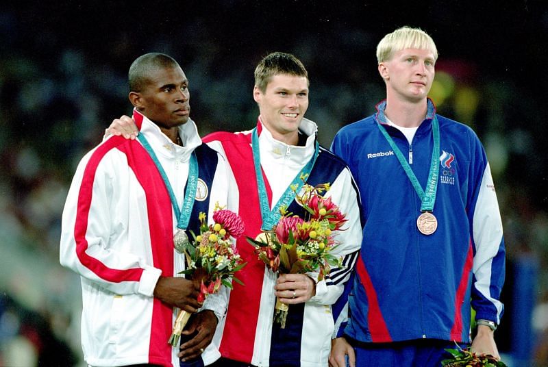 Gold Medal winner Nick Hysong of the USA stands with Lawrence Johnson of the USA who wins the Silver and Maksim Tarasov who wins the Bronze in the Mens Pole Vault during the Sydney 2000 Olympic Games