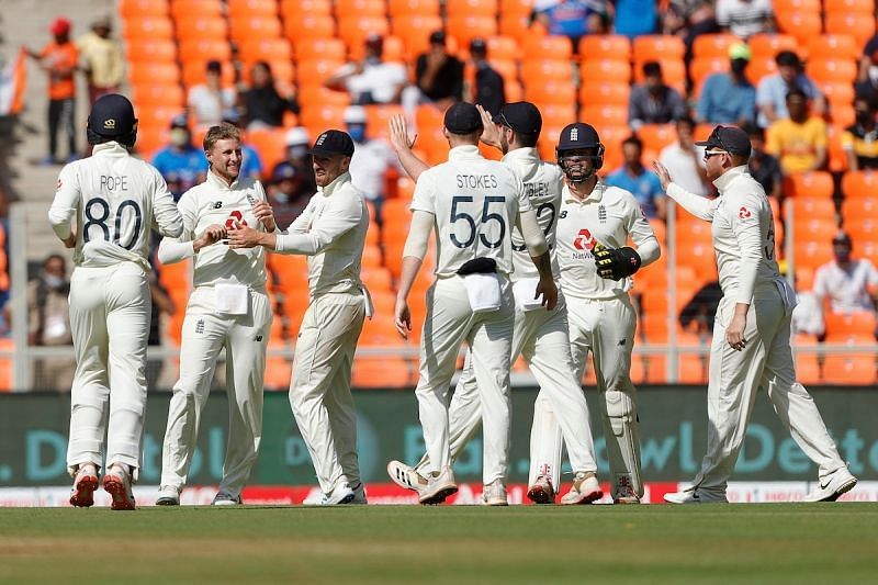Joe Root rejoices with teammates after picking up a wicket in the third Test.