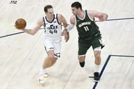 Bojan Bogdanovic #44 of the Utah Jazz passes around Brook Lopez #11 of the Milwaukee Bucks.