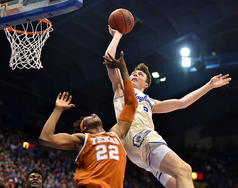 Christian Braun #2 of the Kansas Jayhawks is fouled by Kai Jones #22 of the Texas Longhorns