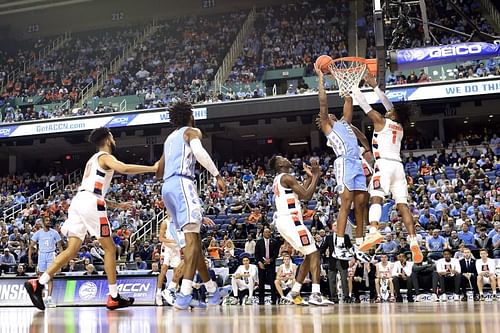 Armando Bacot #5 of the North Carolina Tar Heels attempts a shot against Quincy Guerrier #1 of the Syracuse Orange