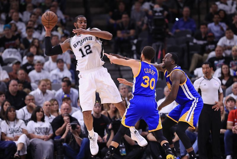 LaMarcus Aldridge #12 of the San Antonio Spurs looks to pass the ball against Stephen Curry #30 and Draymond Green #23 of the Golden State Warriors in the first half during Game Three of the 2017 NBA Western Conference Finals at AT&amp;T Center on May 20, 2017 in San Antonio, Texas. (Photo by Ronald Martinez/Getty Images)