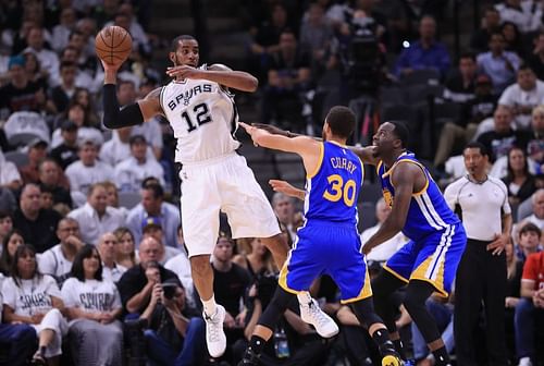 LaMarcus Aldridge #12 of the San Antonio Spurs looks to pass the ball against Stephen Curry #30 and Draymond Green #23 of the Golden State Warriors in the first half during Game Three of the 2017 NBA Western Conference Finals at AT&T Center on May 20, 2017 in San Antonio, Texas. (Photo by Ronald Martinez/Getty Images)