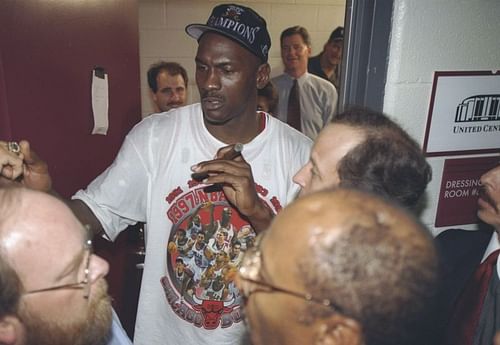 Michael Jordan of the Chicago Bulls is interviewed in the locker room after the Bulls win game 6 of the 1997 NBA Finals