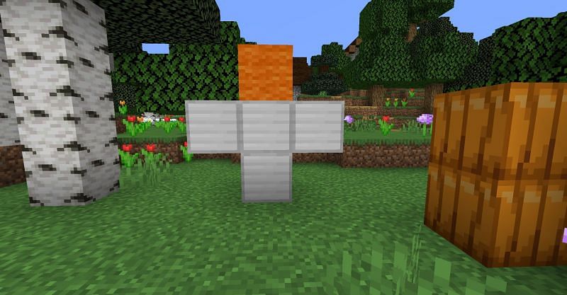 The pattern to make an Iron Golem in Minecraft, with the piece of orange wool representing where the pumpkin head should go (Image via Minecraft)