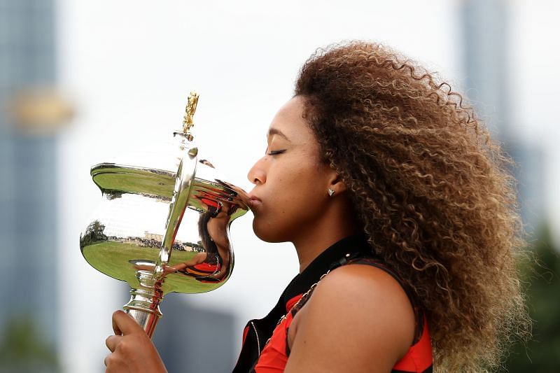 Naomi Osaka kisses the Australian Open trophy