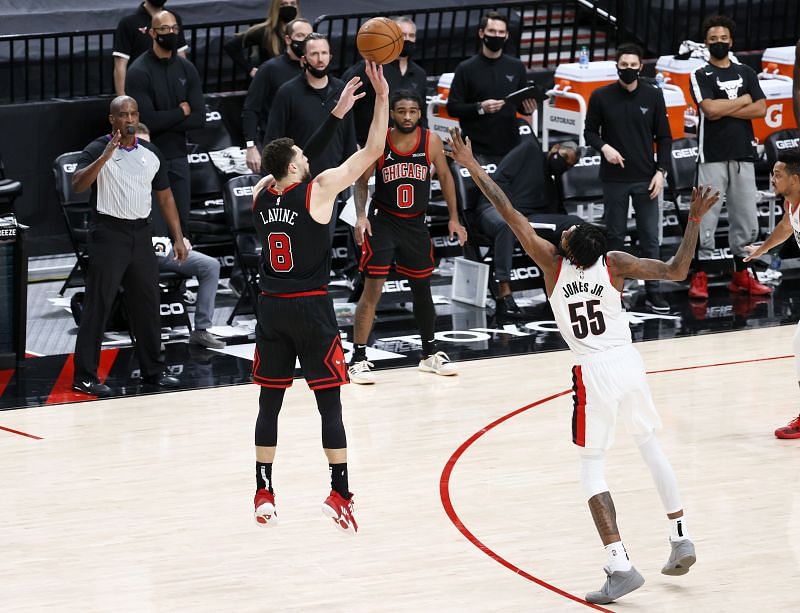 Zach LaVine #8 of the Chicago Bulls shoots a three point basket against Derrick Jones Jr. #55 of the Portland Trail Blazers in the fourth quarter at Moda Center (Photo by Steph Chambers/Getty Images)