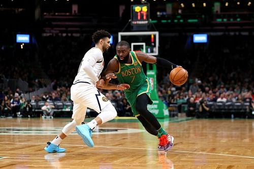 Jaylen Brown (#7) of the Boston Celtics drives against Jamal Murray (#27) of the Denver Nuggets.