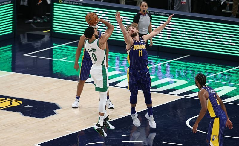 Domantas Sabonis #11 of the Indiana Pacers defends the shot of Jayson Tatum #0 of the Boston Celtics