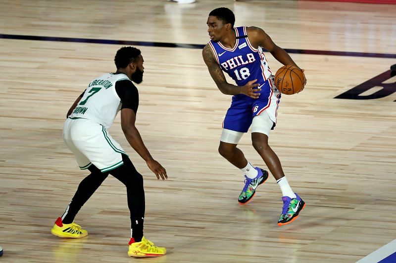 Shake Milton of the Philadelphia 76ers controls the ball against Jaylen Brown of the Boston Celtics
