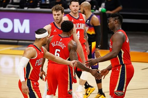 Zion Williamson, Josh Hart, and Eric Bledsoe of the New Orleans Pelicans celebrate after scoring against the Phoenix Suns (Photo by Christian Petersen/Getty Images)