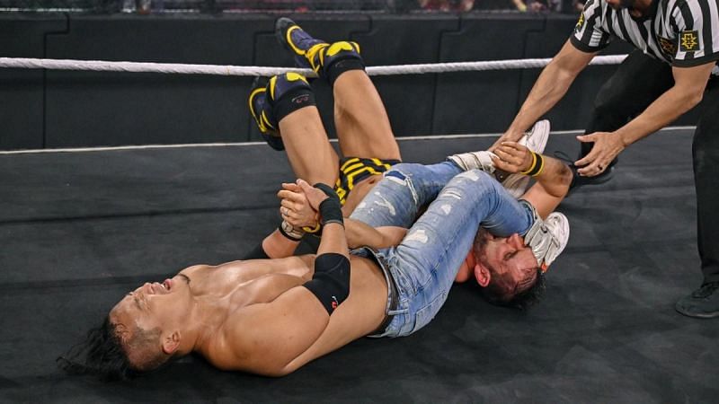 Kushida working on Gargano&#039;s arm during their North American title match at NXT TakeOver Vengeance Day.