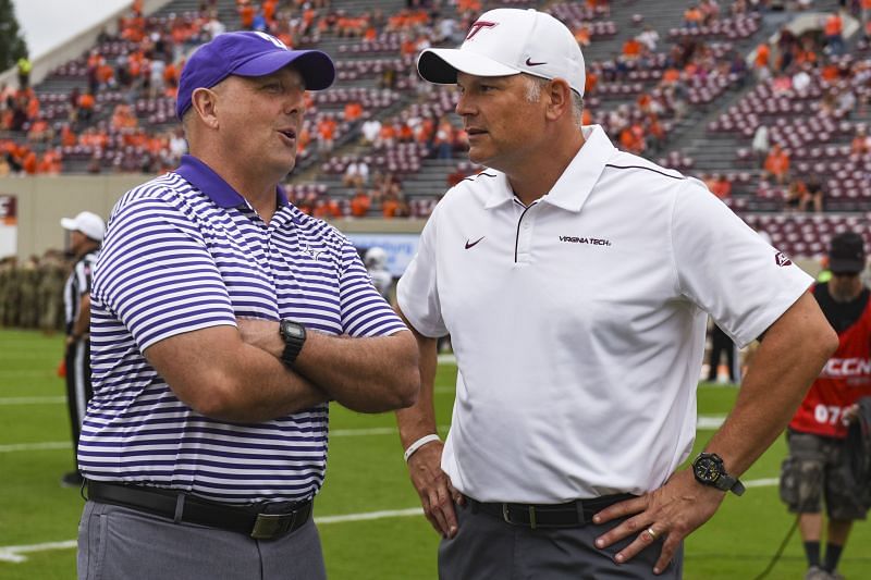 Furman head coach Clay Hendrix speaks with Virginia Tech head coach Justin Fuente.