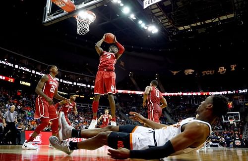 The Oklahoma Sooners grabs a rebound against the Oklahoma State Cowboys.