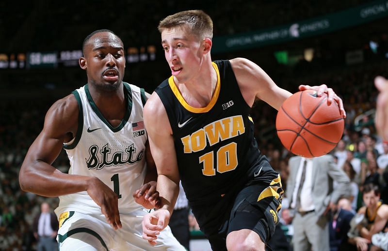 Joe Wieskamp #10 of the Iowa Hawkeyes drives to the basket while defended by Joshua Langford #1 of the Michigan State Spartans