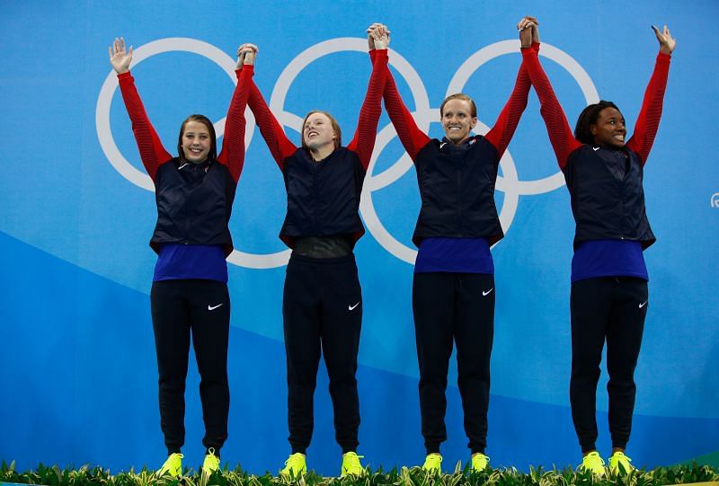 Kathleen Baker, Lilly King, Dana Vollmer, Simone Manuel (from left to right) of the United States celebrate on the podium after winning the Women&#039;s 4 x 100m Medley Relay Final at the Rio 2016 Olympics.