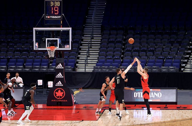 Brook Lopez of the Milwaukee Bucks guards a 3-point shot against the Toronto Raptors