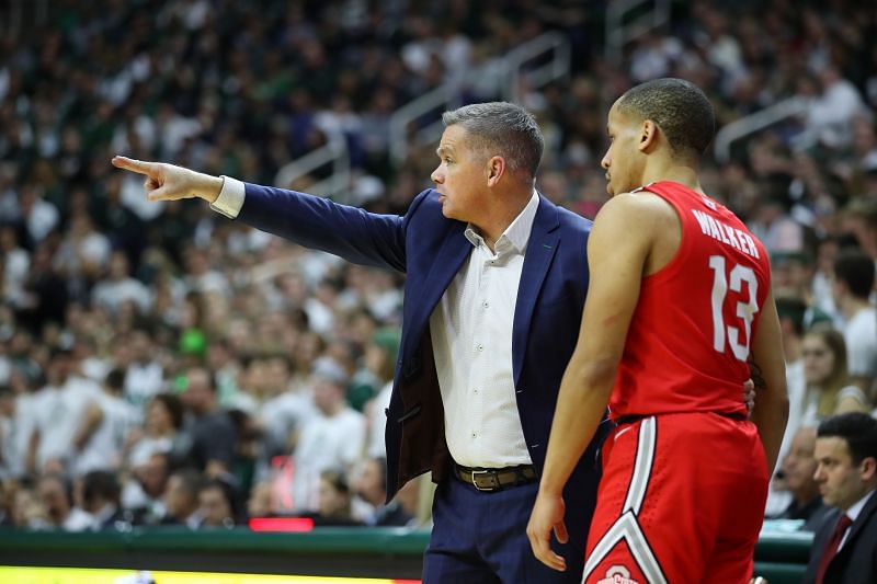 Head coach Chris Holtmann of the Ohio State Buckeyes talks to CJ Walker #13 while playing the Michigan State Spartans